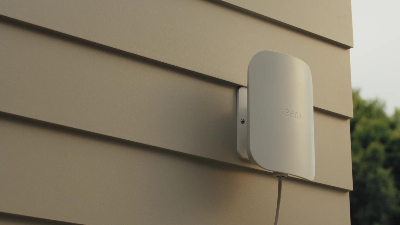 An eero Outdoor 7 mounted on the side of a house